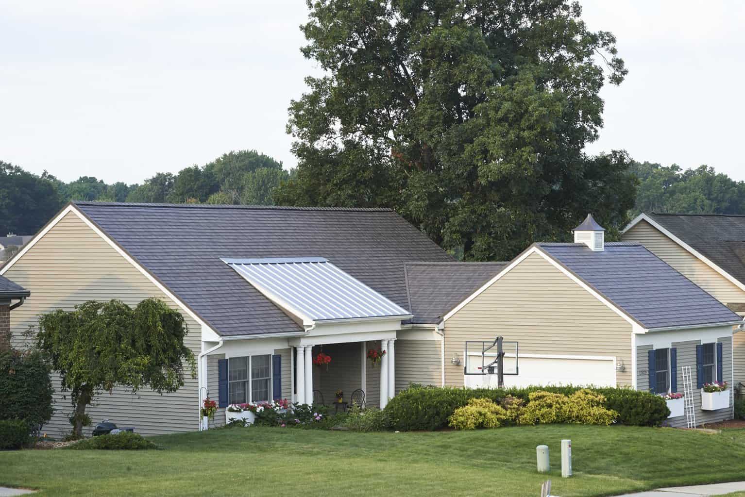 Image shows the exterior of a home with grey shingled roof