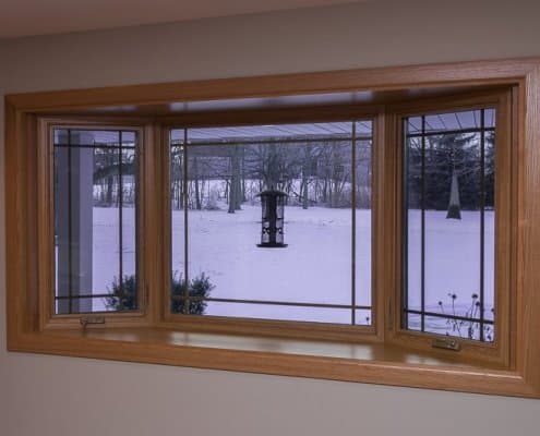 Bay window with prairie grids, golden oak interior stain and laminated seat in Franklin, WI