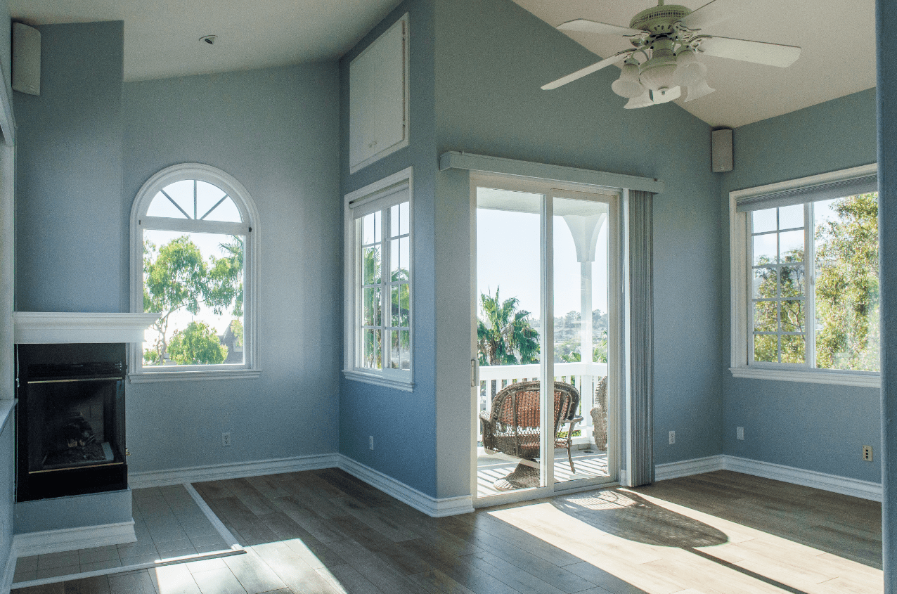 Image shows a light blue interior room with white trim and lots of natural light