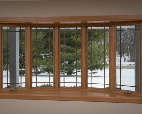 Bow window with prairie grids, vinyl windows, wood grain grids and golden oak interior in Franklin, WI