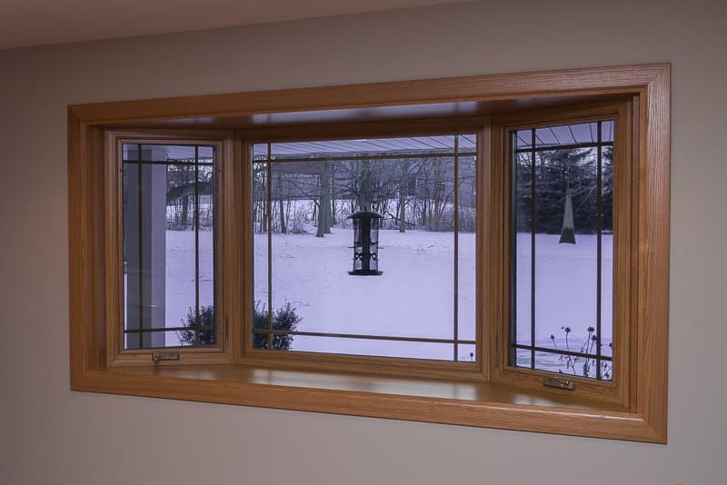 Bay window with prairie grids, golden oak interior stain and laminated seat in Franklin, WI