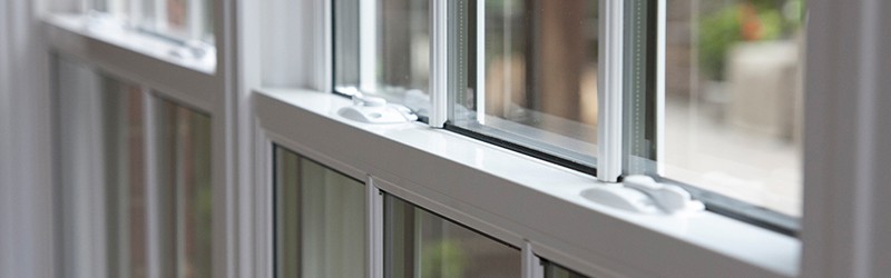 Image shows a close up of two double hung windows